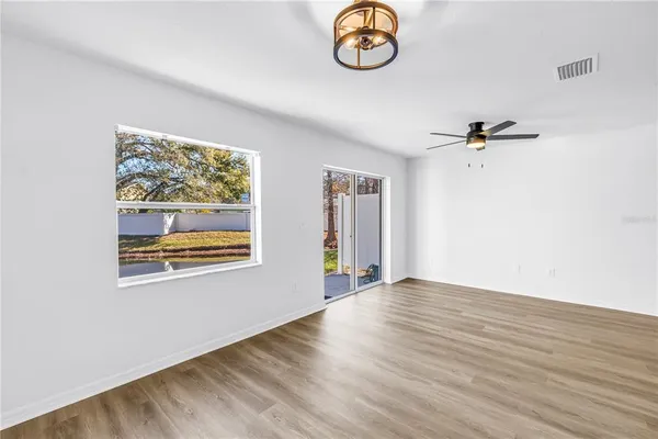 a kitchen with a sink a microwave a refrigerator and cabinets