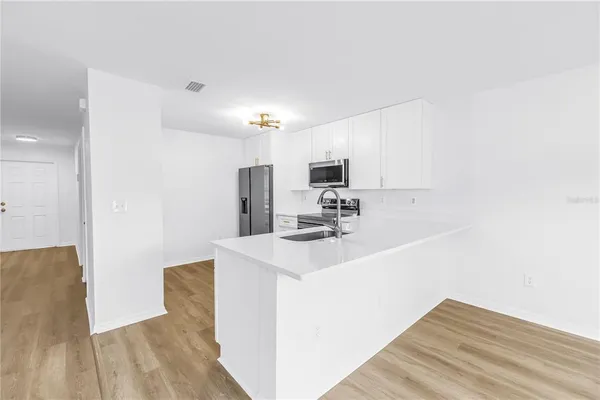 a white toilet sitting next to a white sink