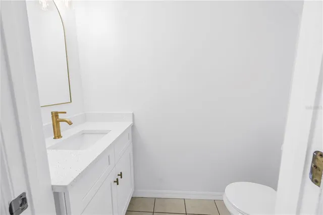 an empty room with wooden floor closet and windows