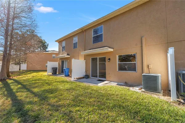 front view of a brick house with a yard