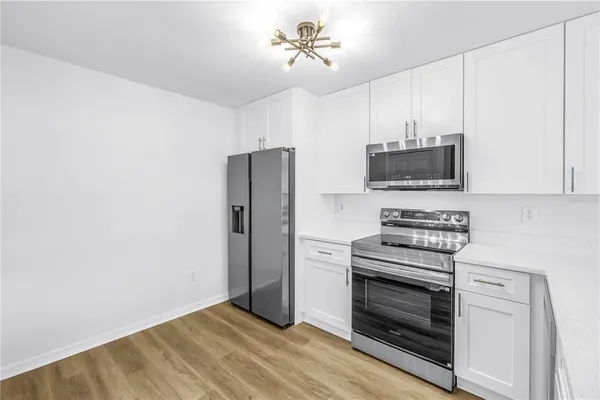 a kitchen with a sink stainless steel appliances and cabinets