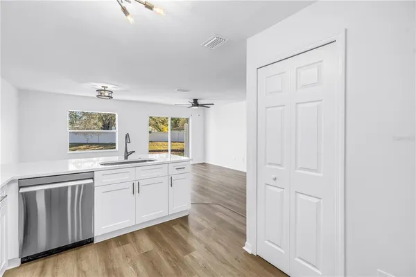 a kitchen with granite countertop a sink and cabinets