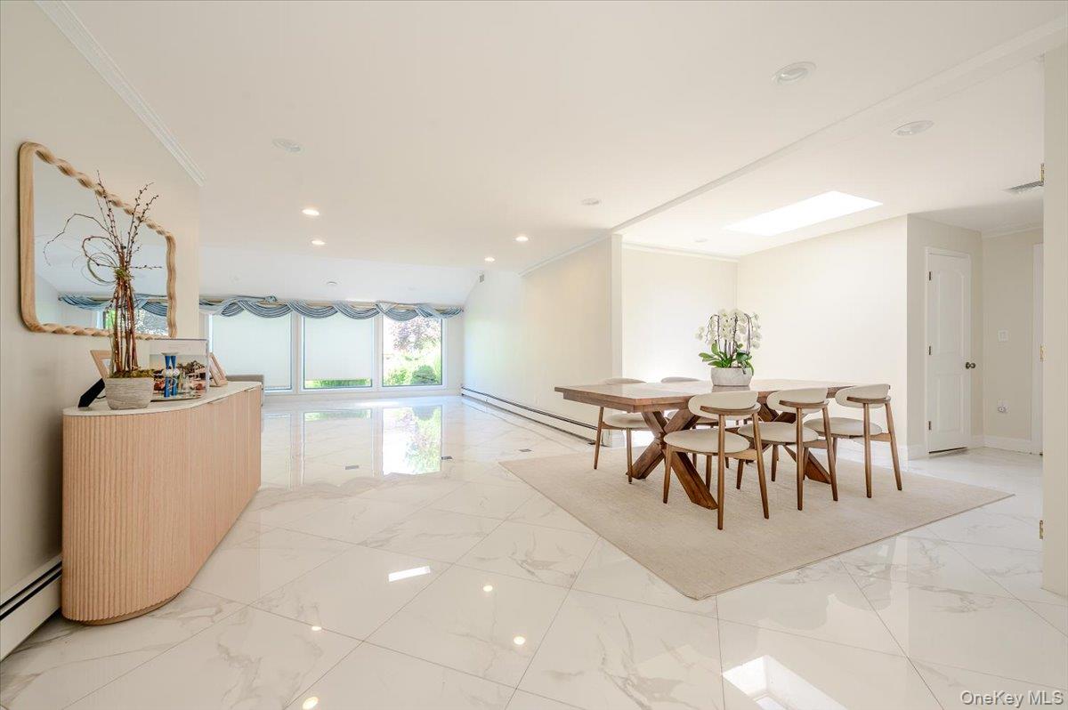 70 Longfellow Road Great Neck, NY 11023 - Photo 13 of 28 a dining hall with stainless steel appliances a dining table chairs and couches