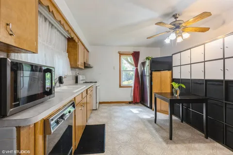 a kitchen with stainless steel appliances granite countertop a stove and a sink