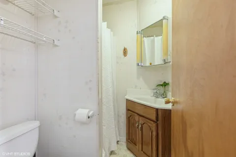 a bathroom with a sink a toilet and mirror