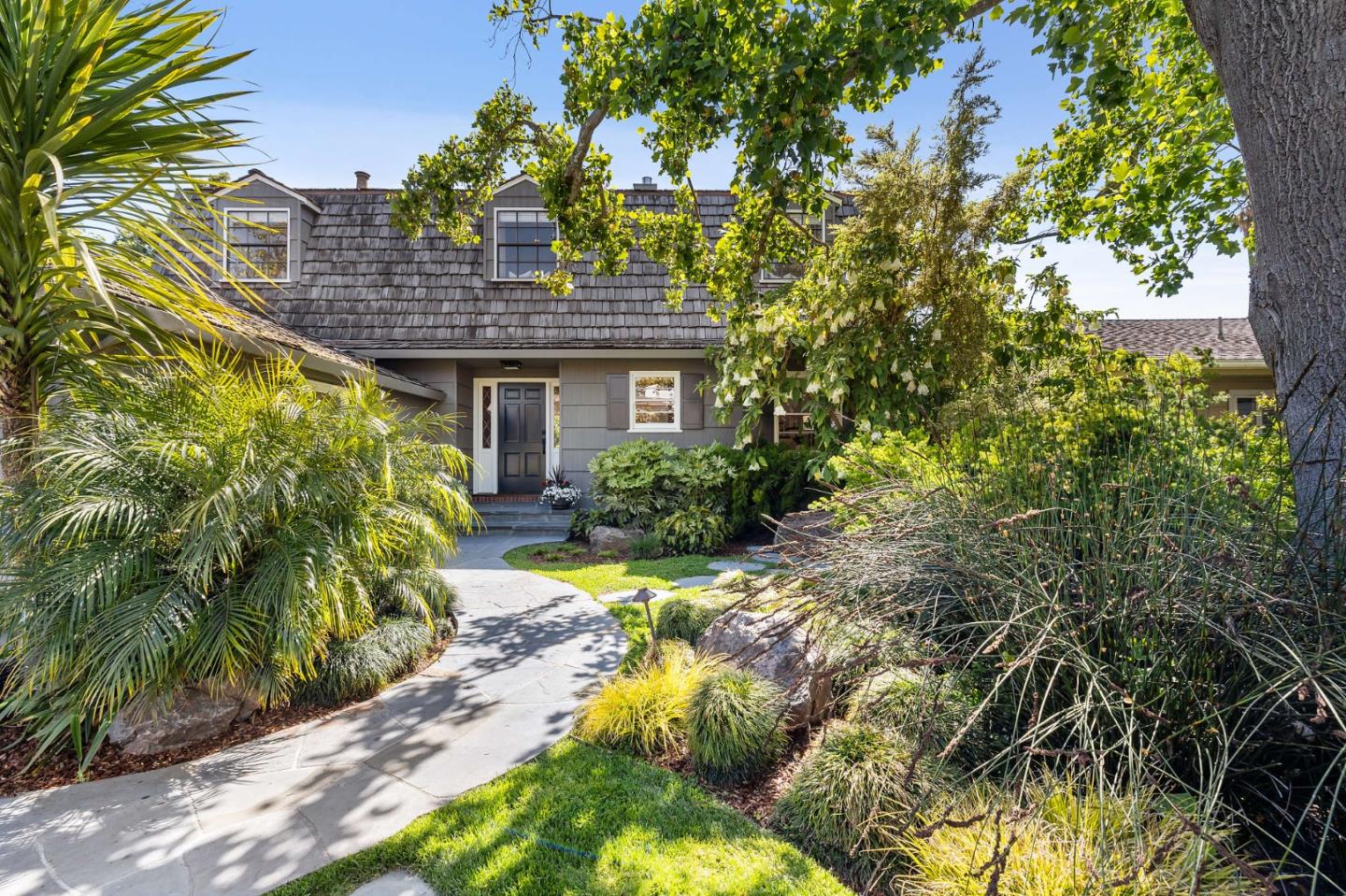 a view of a house with a small yard and plants