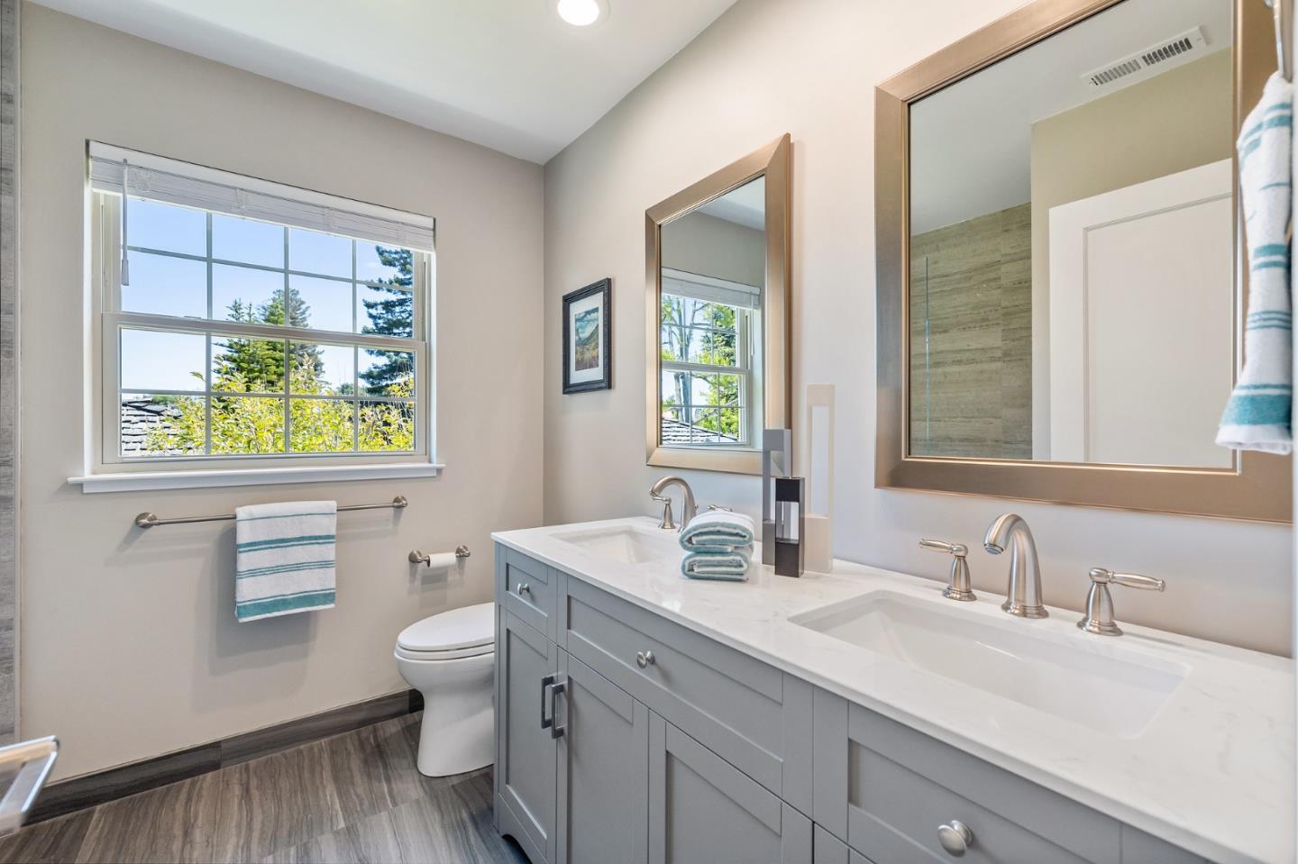 514 Alhambra Road San Mateo, CA 94402 - Photo 12 of 16 a bathroom with a granite countertop toilet sink and mirror