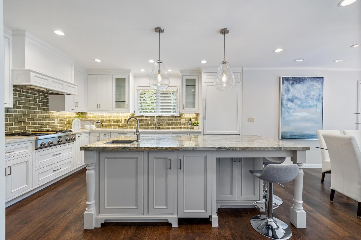 514 Alhambra Road San Mateo, CA 94402 - Photo 4 of 16 a kitchen with granite countertop a sink chairs and wooden floor