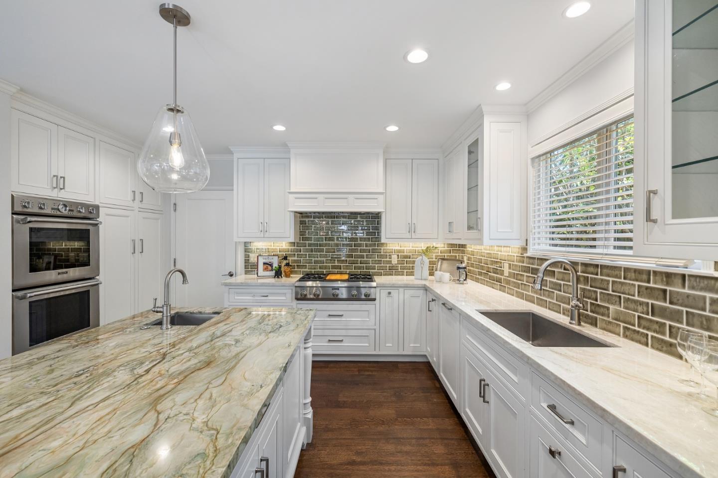 514 Alhambra Road San Mateo, CA 94402 - Photo 5 of 16 a large kitchen with granite countertop a large counter top a sink stainless steel appliances and cabinets