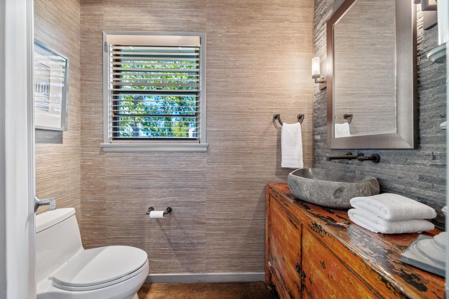 514 Alhambra Road San Mateo, CA 94402 - Photo 7 of 16 a bathroom with a granite countertop toilet sink and mirror