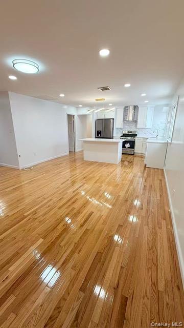 151-28 24th Road Queens, NY 11357 - Photo 5 of 8 Unfurnished living room with recessed lighting and light wood-type flooring