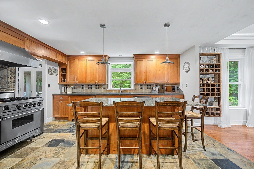 4 Dicarlo Road Hopkinton, MA 01748 - Photo 5 of 41 a kitchen with stainless steel appliances a stove a sink dishwasher and a refrigerator with wooden floor