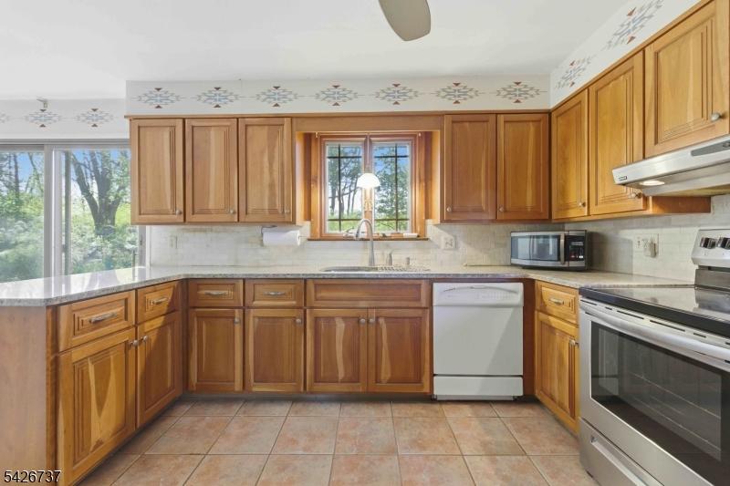117 Linaberry Road Columbia, NJ 07832 - Photo 8 of 36 a kitchen with stainless steel appliances granite countertop a stove a sink and a microwave