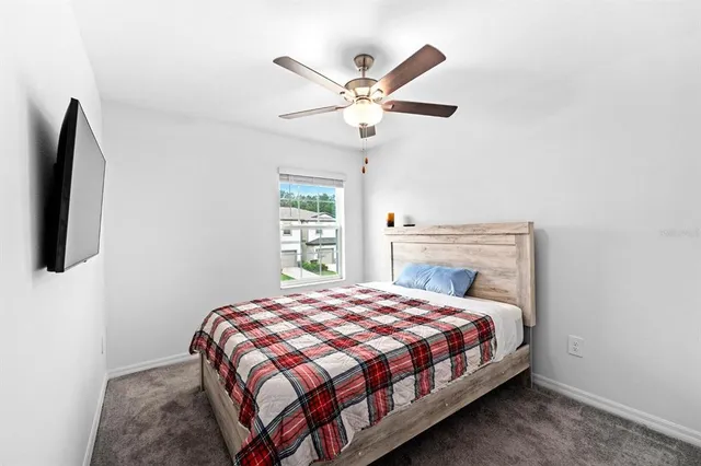 a bedroom with a bed and a chandelier