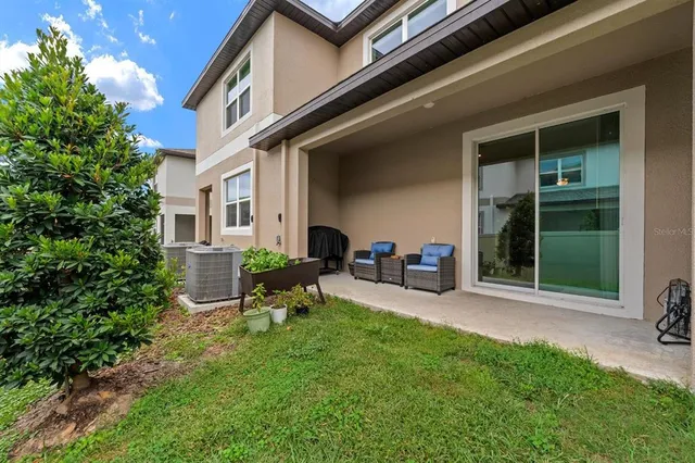 a view of a house with backyard porch and sitting area