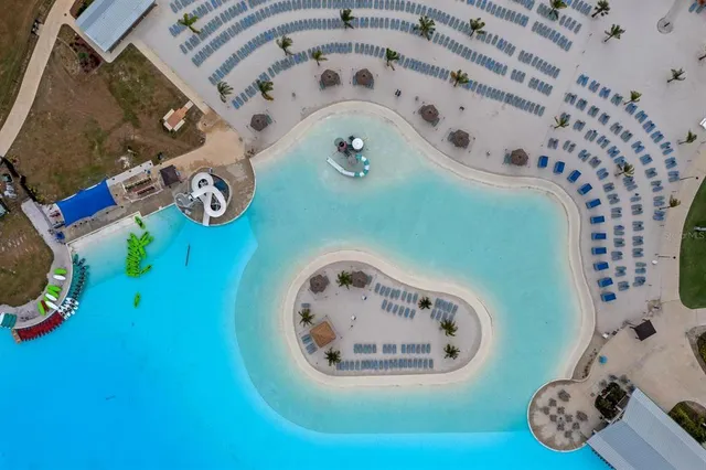 an aerial view of a swimming pool with outdoor seating