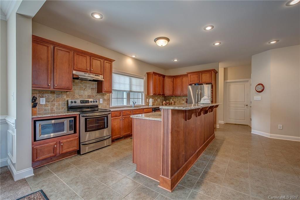 1072 Arabian Farm Road, Unit 9 Clover, SC 29710 - Photo 15 of 24 a kitchen with stainless steel appliances granite countertop a stove top oven a sink and dishwasher