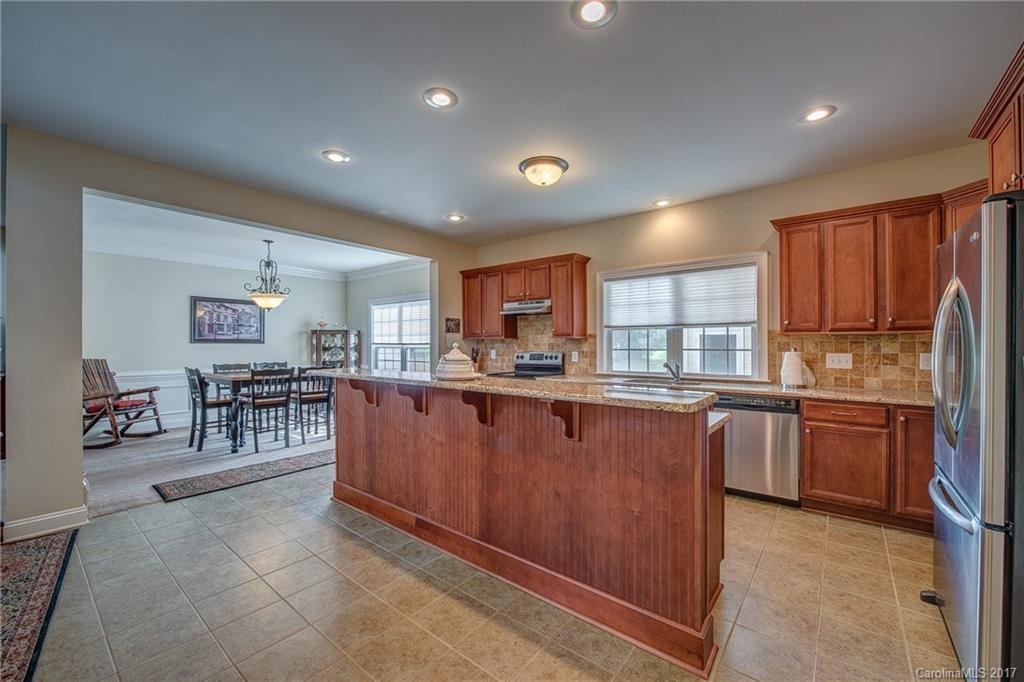1072 Arabian Farm Road, Unit 9 Clover, SC 29710 - Photo 16 of 24 a kitchen with stainless steel appliances granite countertop a refrigerator and wooden cabinets