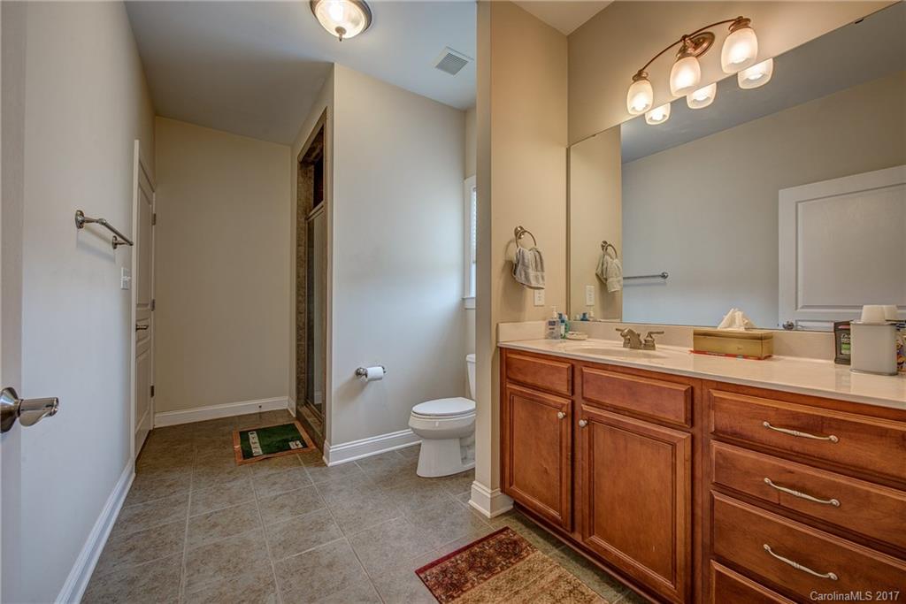1072 Arabian Farm Road, Unit 9 Clover, SC 29710 - Photo 19 of 24 a spacious bathroom with a double vanity sink a toilet and a mirror
