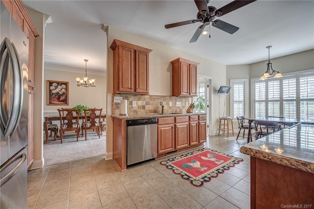 1072 Arabian Farm Road, Unit 9 Clover, SC 29710 - Photo 7 of 24 a kitchen with stainless steel appliances granite countertop a stove refrigerator and a sink