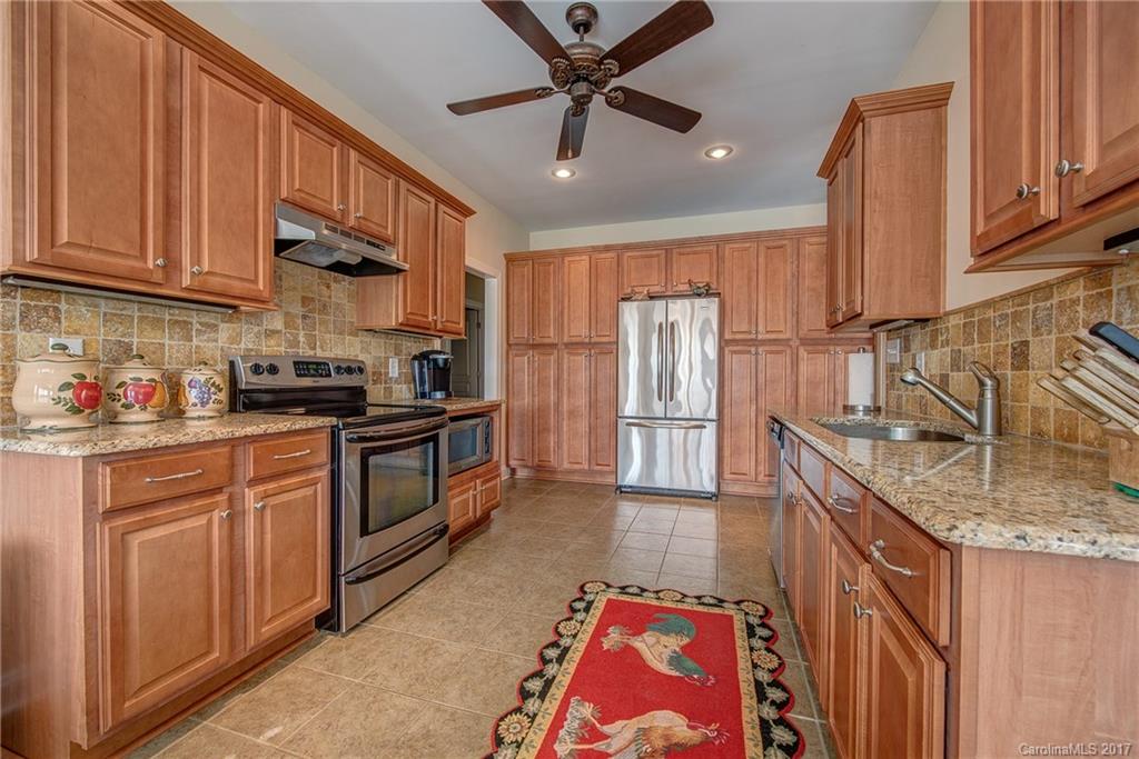 1072 Arabian Farm Road, Unit 9 Clover, SC 29710 - Photo 8 of 24 a kitchen with stainless steel appliances granite countertop a refrigerator a stove top oven a sink and dishwasher