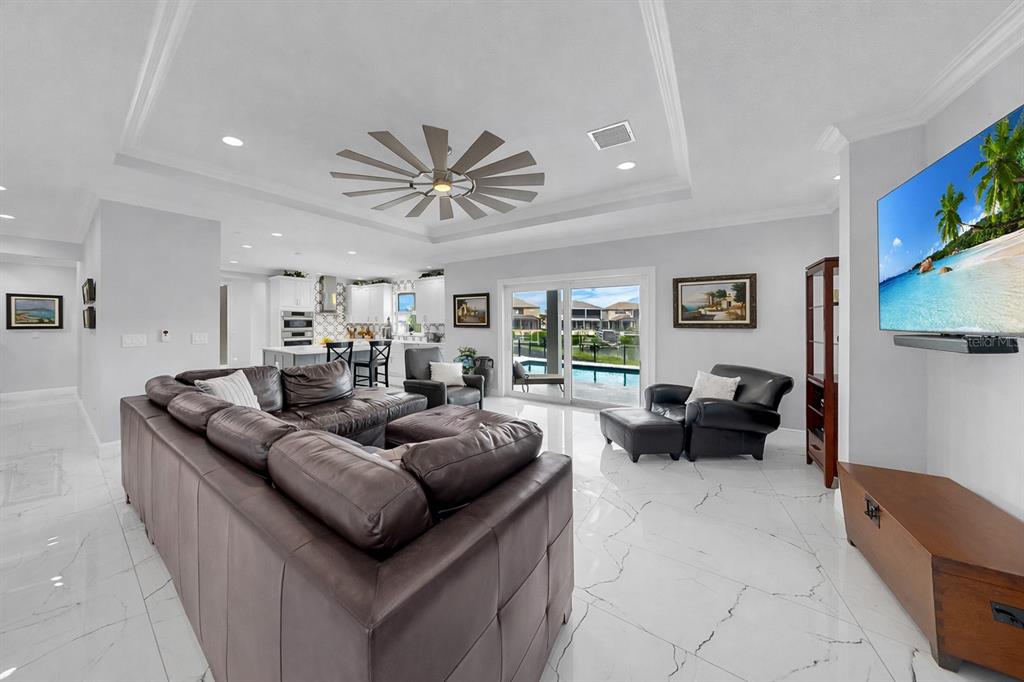 901 Capriccio Lane Apollo Beach, FL 33572 - Photo 16 of 83 a living room with furniture and a chandelier