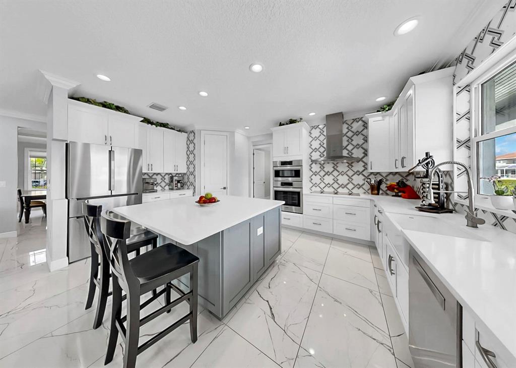 901 Capriccio Lane Apollo Beach, FL 33572 - Photo 18 of 83 a large kitchen with stainless steel appliances lots of counter space and breakfast area