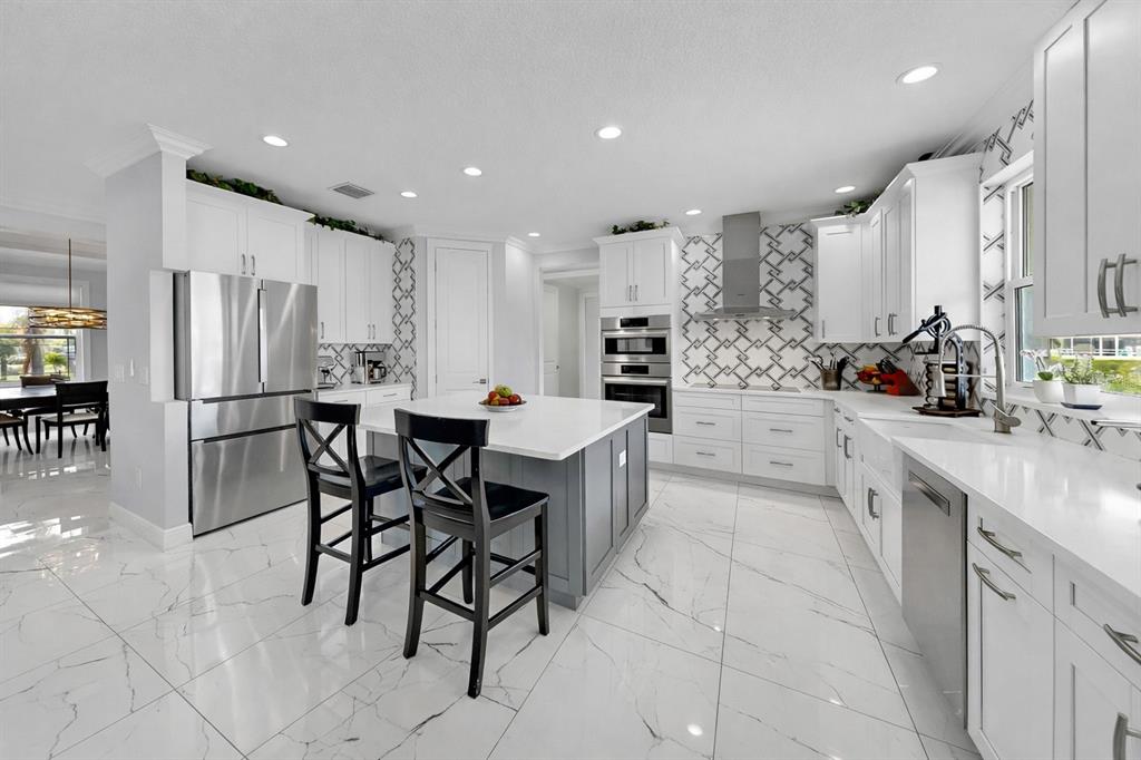 901 Capriccio Lane Apollo Beach, FL 33572 - Photo 26 of 83 a kitchen with stainless steel appliances a sink counter space and appliances