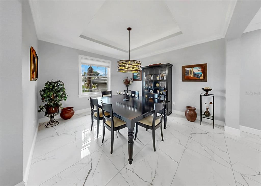 901 Capriccio Lane Apollo Beach, FL 33572 - Photo 28 of 83 a view of a dining room with furniture and chandelier