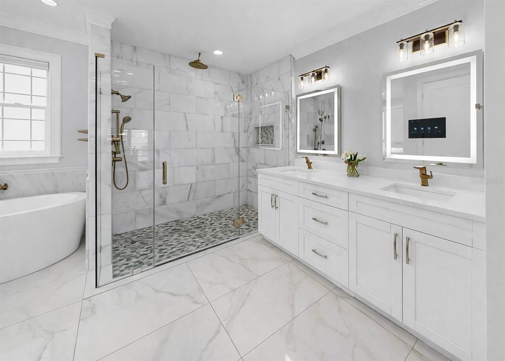 901 Capriccio Lane Apollo Beach, FL 33572 - Photo 39 of 83 a spacious bathroom with double sink shower and mirror