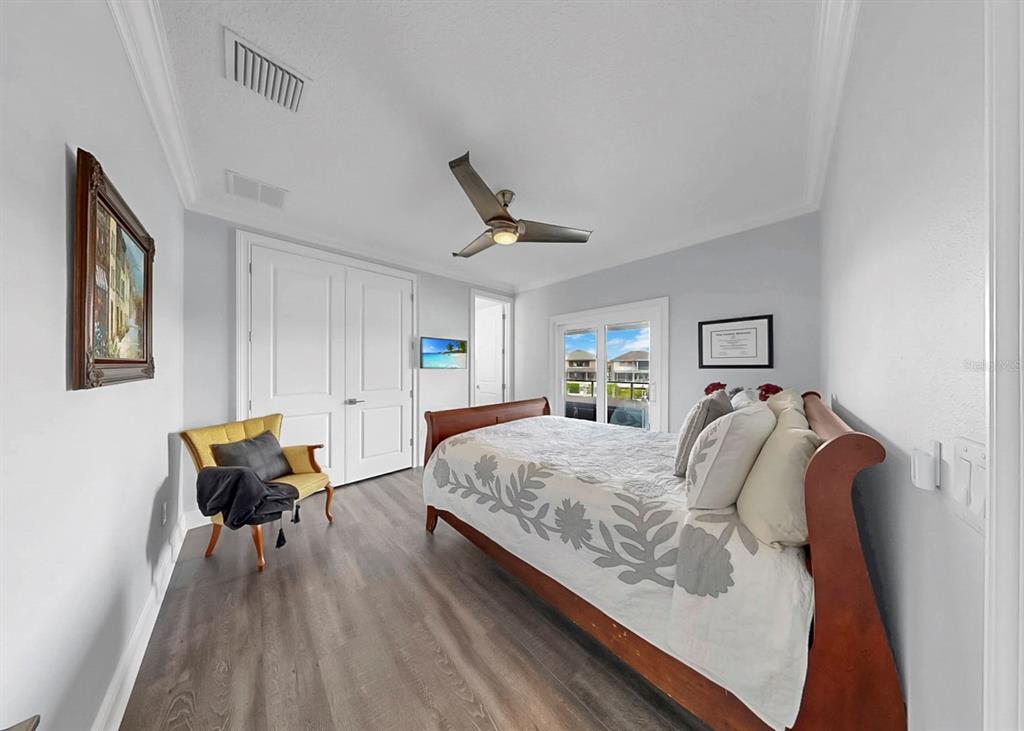 901 Capriccio Lane Apollo Beach, FL 33572 - Photo 44 of 83 a bed room with a bed and a chair