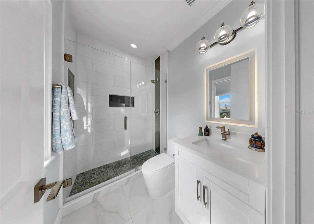 901 Capriccio Lane Apollo Beach, FL 33572 - Photo 47 of 83 a bathroom with a sink double vanity mirror and a bathtub