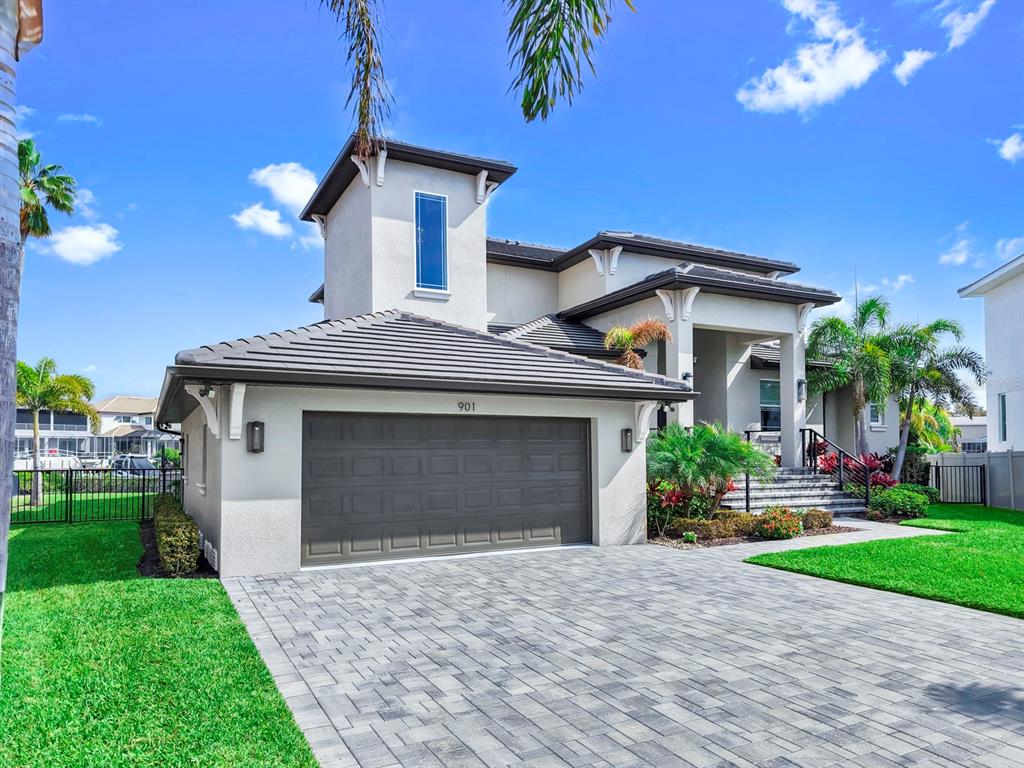 901 Capriccio Lane Apollo Beach, FL 33572 - Photo 71 of 83 a front view of a house with a yard and garage