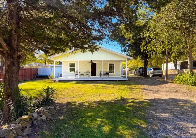a front view of a house with swimming pool having outdoor seating