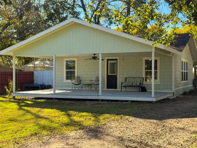 a view of a house with pool and sitting area
