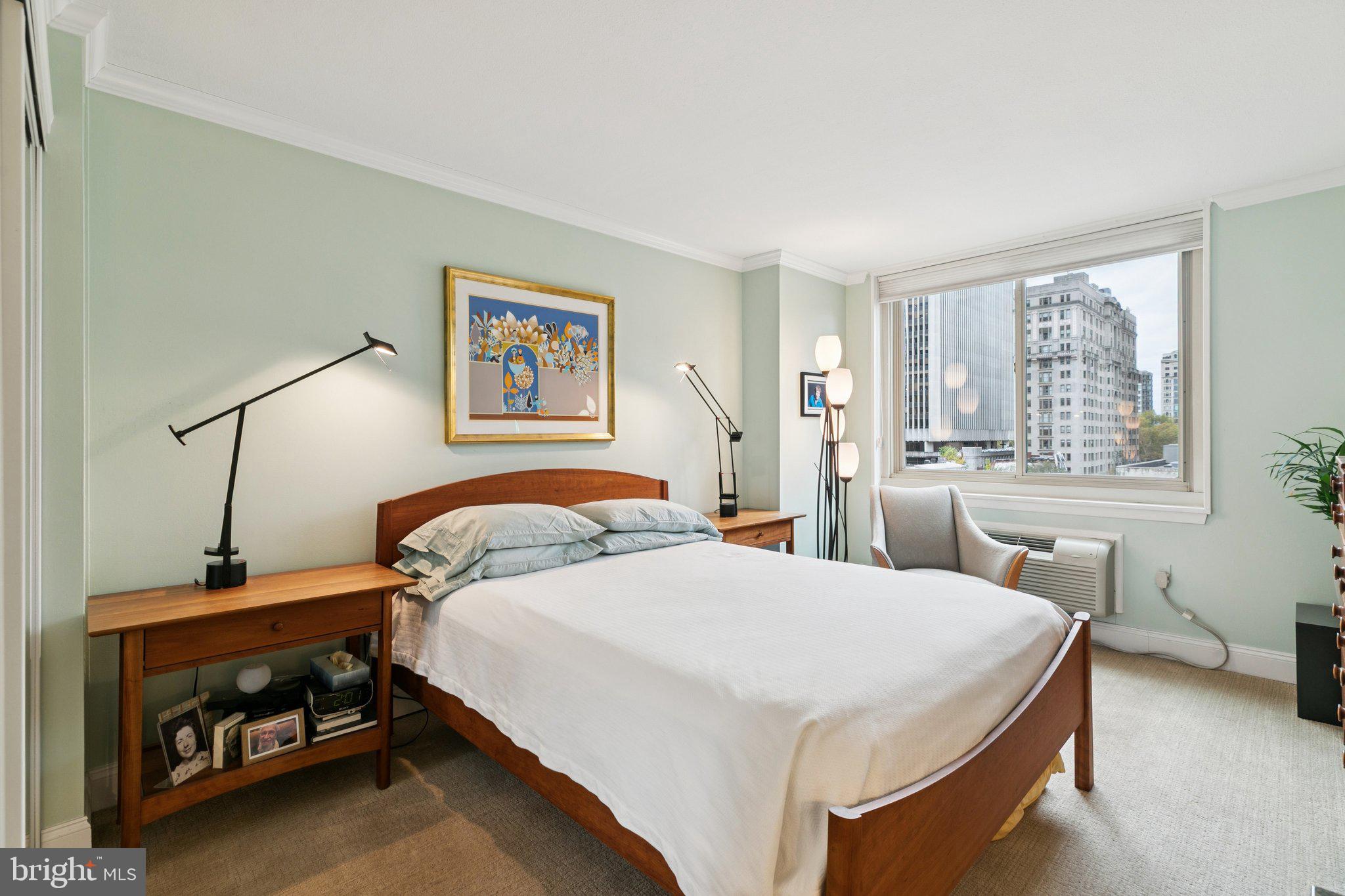 1919 Chestnut Street, Unit 707 Philadelphia, PA 19103 - Photo 19 of 36 a bedroom with a bed and a table