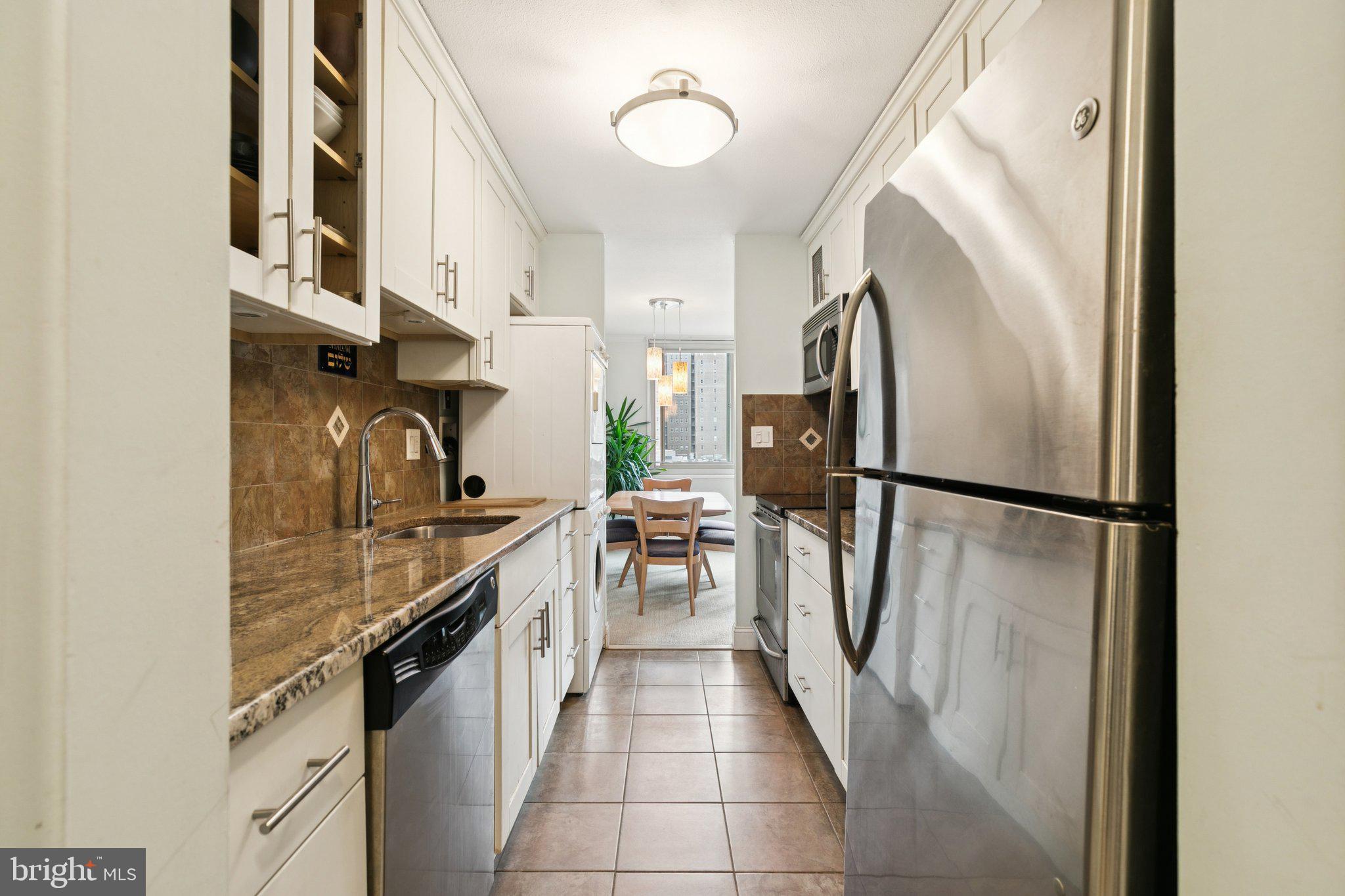 1919 Chestnut Street, Unit 707 Philadelphia, PA 19103 - Photo 6 of 36 a kitchen with stainless steel appliances granite countertop a refrigerator a sink and a stove