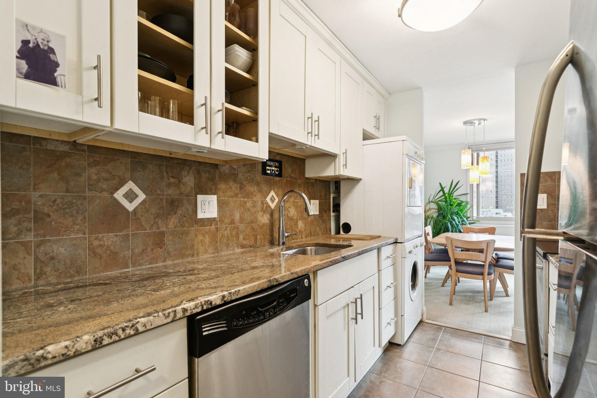 1919 Chestnut Street, Unit 707 Philadelphia, PA 19103 - Photo 7 of 36 a kitchen with stainless steel appliances granite countertop a stove a sink and a refrigerator