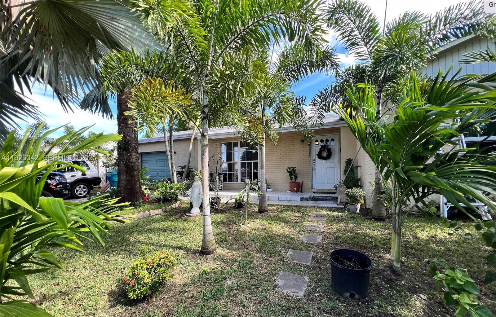 25835 Southwest 131st Court Homestead, FL 33032 - Photo 1 of 1 a backyard of a house with yard and outdoor seating