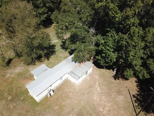 an aerial view of a house with yard and mountain view in back