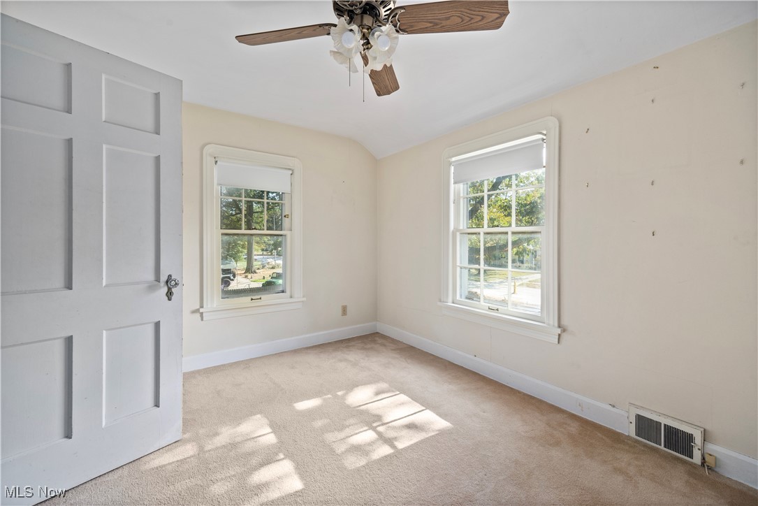 976 Gulf Road Elyria, OH 44035 - Photo 20 of 43 Carpeted empty room with healthy amount of natural light and a ceiling fan
