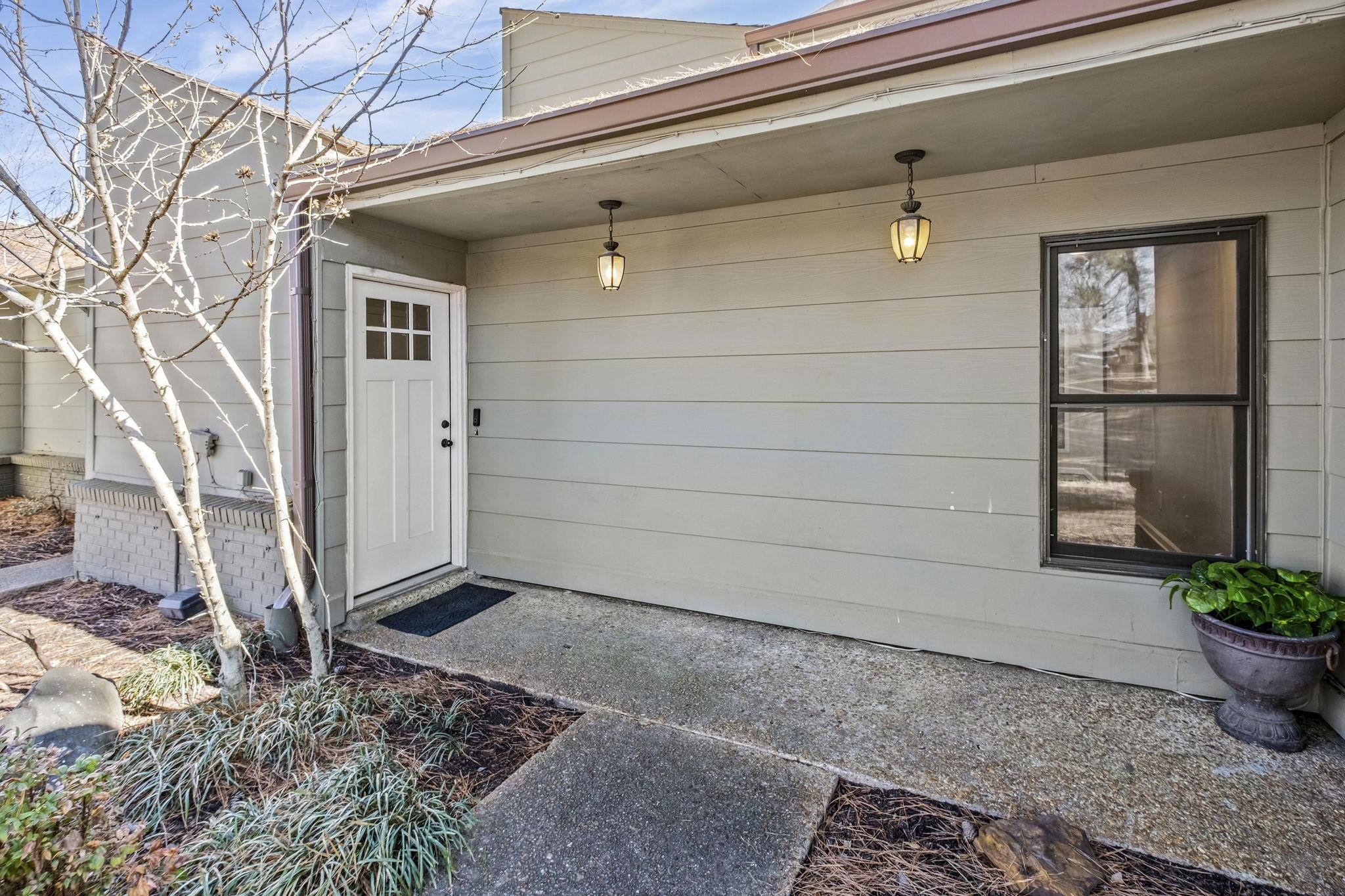 1942 Allenby Road Germantown, TN 38139 - Photo 1 of 34 a potted plant sitting in front of a house