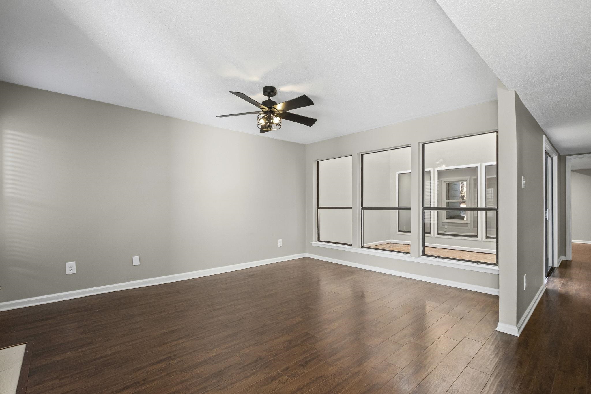 1942 Allenby Road Germantown, TN 38139 - Photo 13 of 34 Unfurnished room with a ceiling fan, dark wood-type flooring, and a textured ceiling