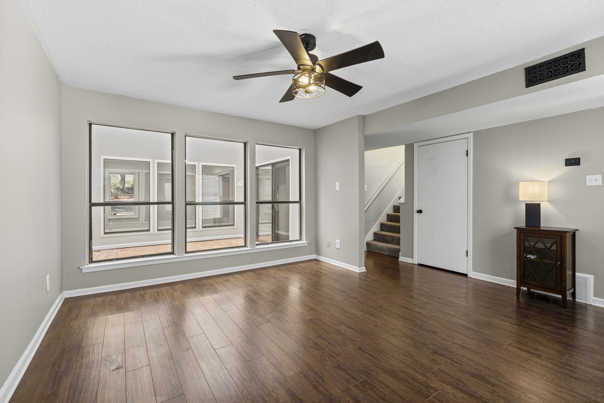 1942 Allenby Road Germantown, TN 38139 - Photo 16 of 34 Unfurnished room featuring ceiling fan, dark wood-style floors, and a textured ceiling