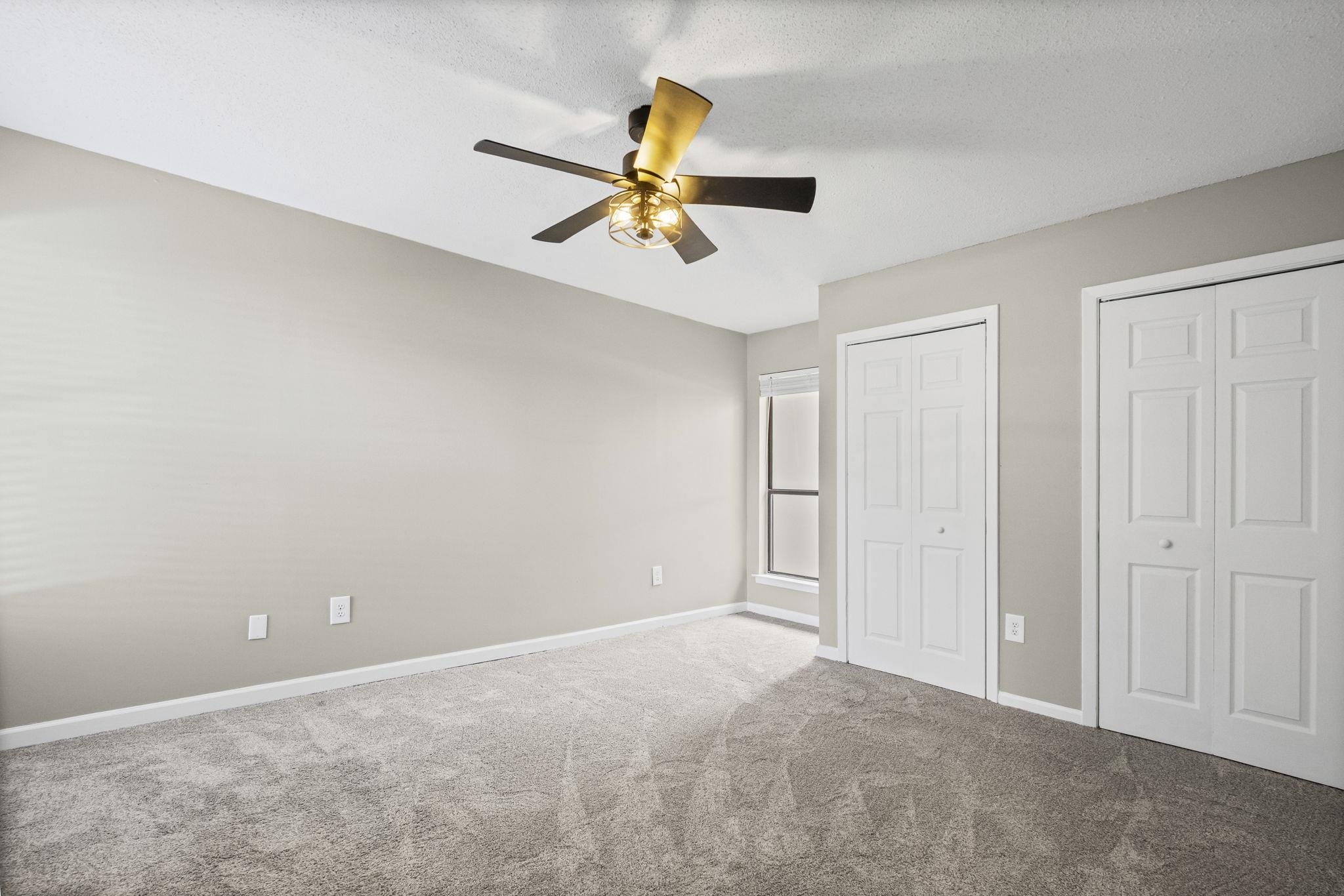 1942 Allenby Road Germantown, TN 38139 - Photo 20 of 34 Unfurnished bedroom featuring multiple closets, carpet floors, and ceiling fan