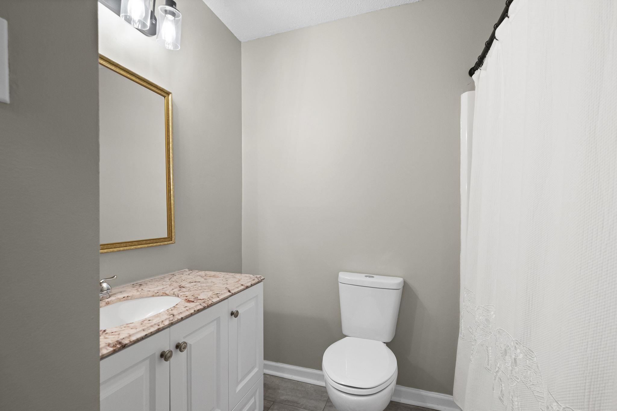 1942 Allenby Road Germantown, TN 38139 - Photo 23 of 34 Full bath with vanity and a shower with curtain