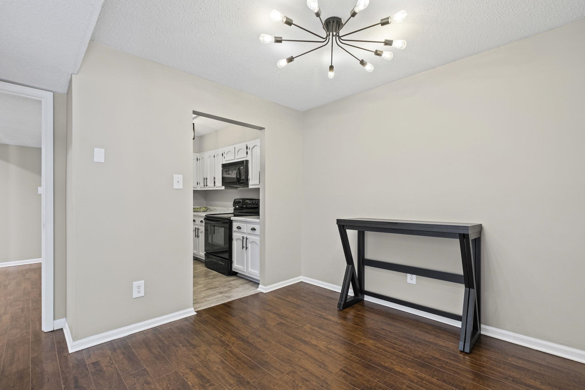 1942 Allenby Road Germantown, TN 38139 - Photo 8 of 34 a view of an empty room with a window and wooden floor