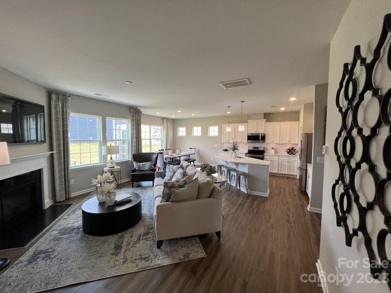 a living room with furniture wooden floor and a fireplace
