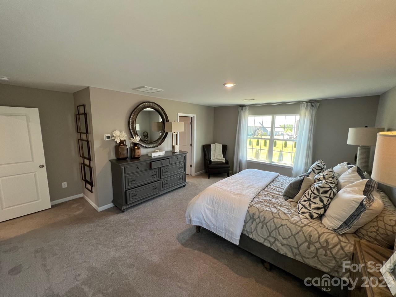 1612 Corwin Bend Road, Unit 2 Tega Cay, SC 29708 - Photo 5 of 7 a spacious bedroom with a bed and a large window