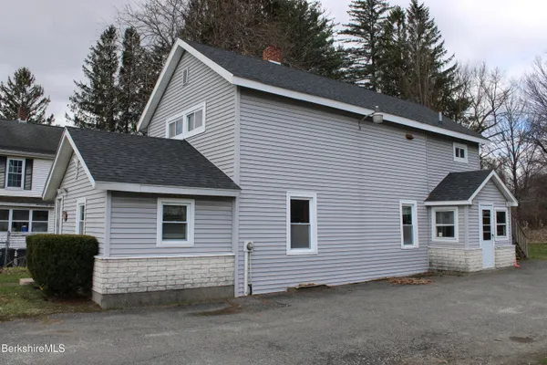 a view of a house with a backyard space